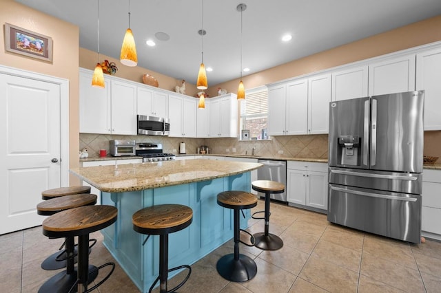 411 Torrington Dr, Austin, TX 78737 - kitchen with stainless steel appliances, white cabinets, a sink, and recessed lighting