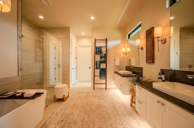 104 Megan Ln, Horseshoe Bay, TX 78657 - bathroom with two vanities, a stall shower, recessed lighting, and a freestanding bath