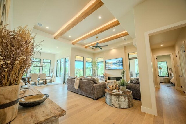 104 Megan Ln, Horseshoe Bay, TX 78657 - living area with light wood finished floors, beamed ceiling, recessed lighting, a ceiling fan, and a glass covered fireplace
