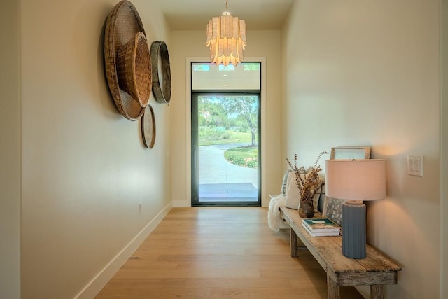 104 Megan Ln, Horseshoe Bay, TX 78657 - doorway to outside featuring wood finished floors, a chandelier, and baseboards