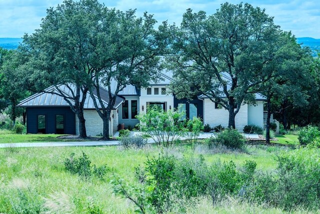 104 Megan Ln, Horseshoe Bay, TX 78657 - view of front of house featuring stone siding and a standing seam roof