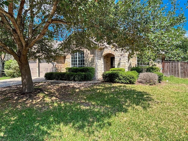 11708 Pillion Pl, Manor, TX 78653 - obstructed view of property with stone siding, driveway, and a garage