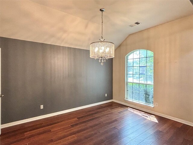 11708 Pillion Pl, Manor, TX 78653 - spare room featuring vaulted ceiling, a chandelier, dark wood finished floors, and baseboards