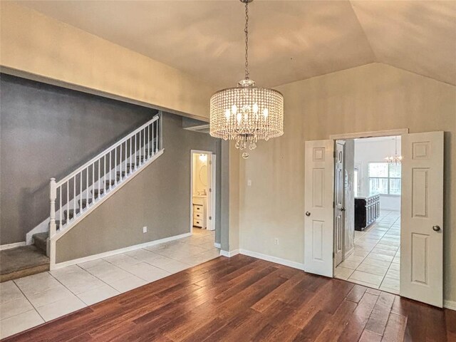 11708 Pillion Pl, Manor, TX 78653 - unfurnished dining area with a chandelier, stairs, wood finished floors, and lofted ceiling