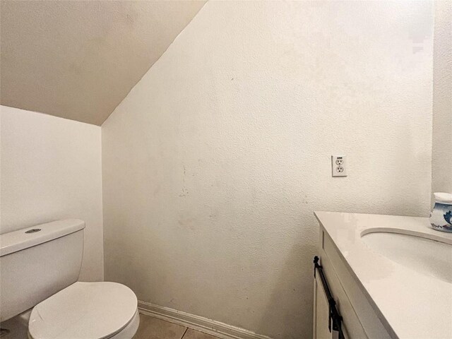 11708 Pillion Pl, Manor, TX 78653 - half bath featuring lofted ceiling, vanity, toilet, and tile patterned flooring