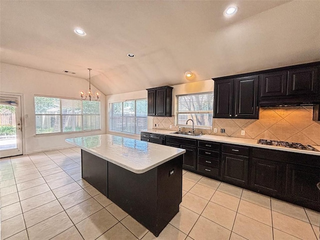 11708 Pillion Pl, Manor, TX 78653 - kitchen with a sink, lofted ceiling, dark cabinets, light countertops, and a chandelier