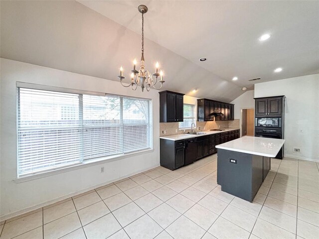 11708 Pillion Pl, Manor, TX 78653 - kitchen with vaulted ceiling, a sink, black microwave, a chandelier, and light countertops