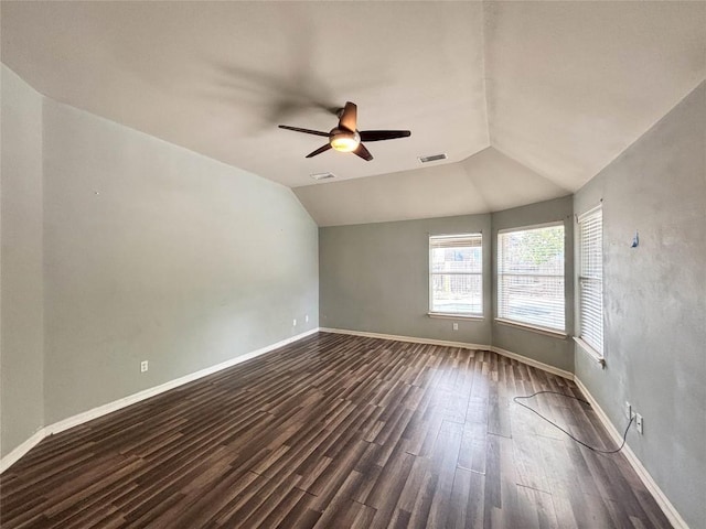 11708 Pillion Pl, Manor, TX 78653 - spare room with dark wood-type flooring, ceiling fan, vaulted ceiling, and baseboards