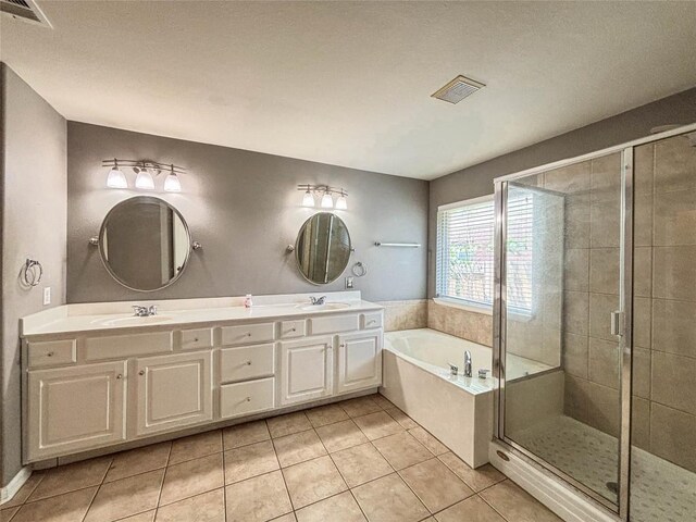 11708 Pillion Pl, Manor, TX 78653 - full bath with a garden tub, double vanity, a stall shower, and tile patterned flooring