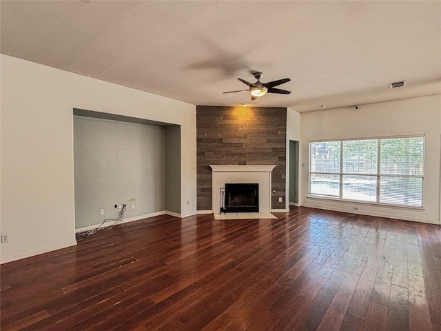11708 Pillion Pl, Manor, TX 78653 - unfurnished living room featuring a ceiling fan, a fireplace with flush hearth, dark wood-style flooring, and baseboards