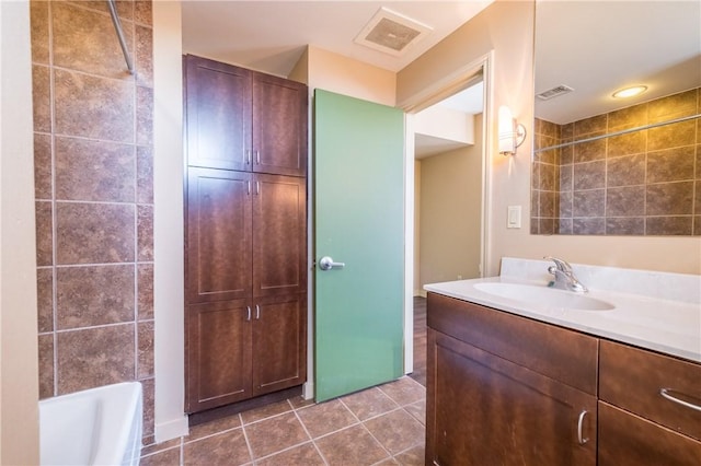 711 W 26th St Unit 703, Austin, TX 78705 - bathroom featuring vanity, a bathtub, tile patterned flooring, and a shower