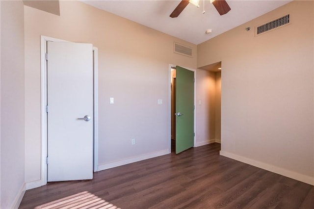 711 W 26th St Unit 703, Austin, TX 78705 - unfurnished bedroom featuring dark wood-style flooring, baseboards, and a ceiling fan