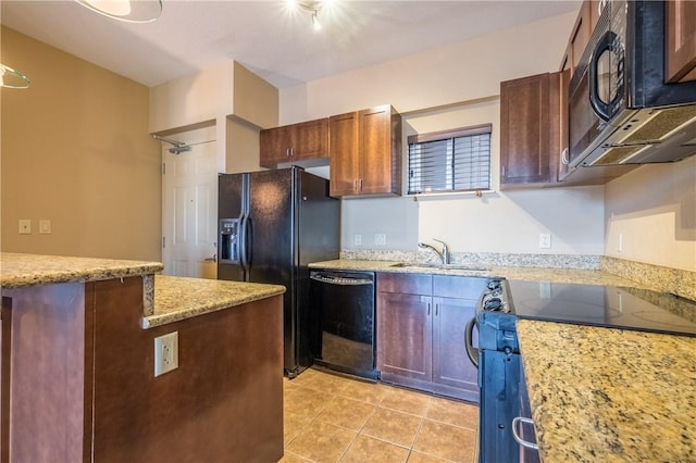 711 W 26th St Unit 703, Austin, TX 78705 - kitchen with black appliances, a sink, light tile patterned floors, and light stone counters