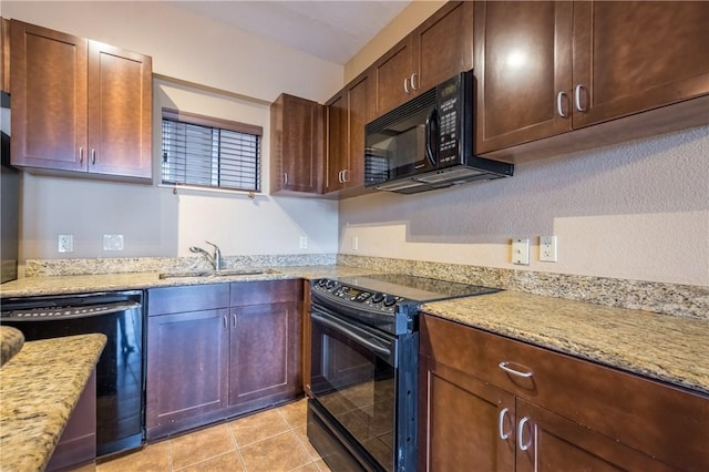 711 W 26th St Unit 703, Austin, TX 78705 - kitchen with black appliances, a sink, light stone countertops, and light tile patterned flooring
