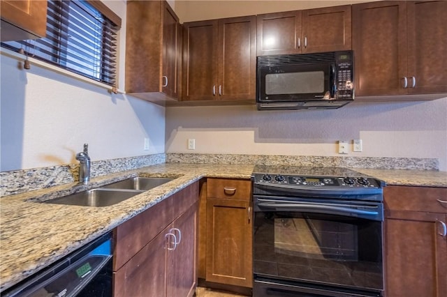 711 W 26th St Unit 703, Austin, TX 78705 - kitchen with black appliances, a sink, and light stone counters