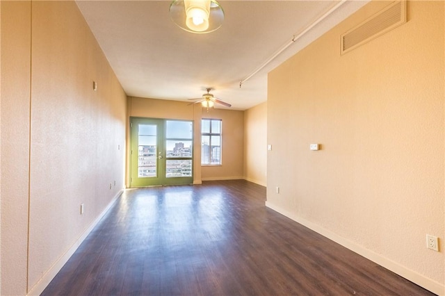711 W 26th St Unit 703, Austin, TX 78705 - spare room featuring a ceiling fan, dark wood finished floors, and baseboards