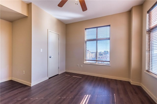 711 W 26th St Unit 703, Austin, TX 78705 - unfurnished bedroom with dark wood-type flooring, baseboards, and a ceiling fan