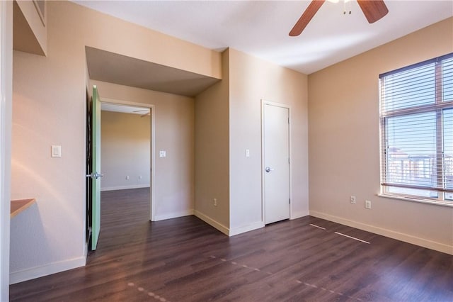 711 W 26th St Unit 703, Austin, TX 78705 - unfurnished bedroom with baseboards, dark wood finished floors, and ceiling fan