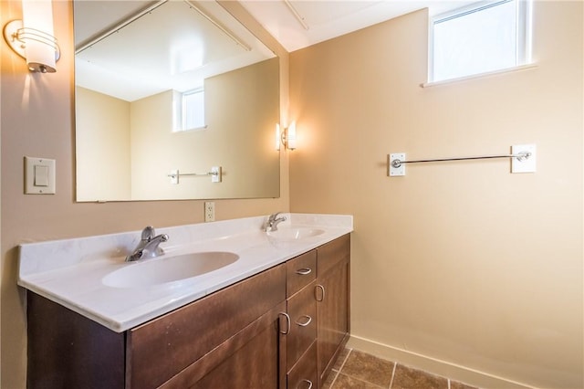 711 W 26th St Unit 703, Austin, TX 78705 - full bathroom with double vanity, tile patterned flooring, and baseboards