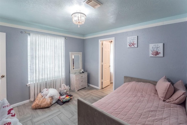 13210 Chriswood Dr, Cypress, TX 77429 - bedroom with a textured ceiling, a chandelier, and baseboards