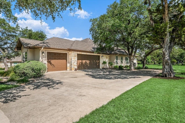 313 Aldea Cv, Georgetown, TX 78633 - view of front of property featuring an attached garage, concrete driveway, stucco siding, a front yard, and stone siding