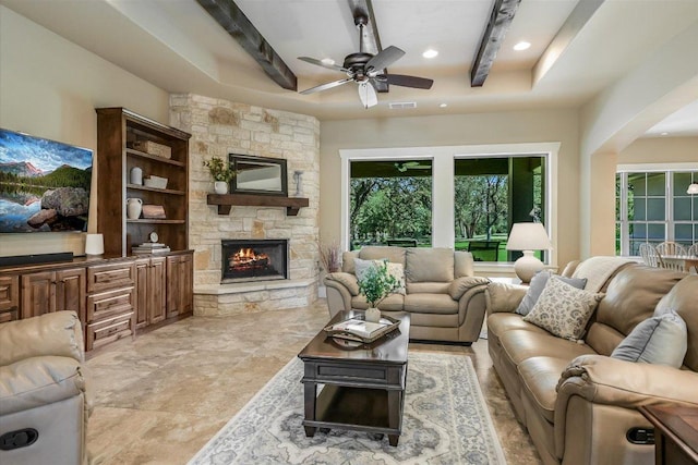 313 Aldea Cv, Georgetown, TX 78633 - living area featuring ceiling fan, a fireplace, recessed lighting, beam ceiling, and a raised ceiling