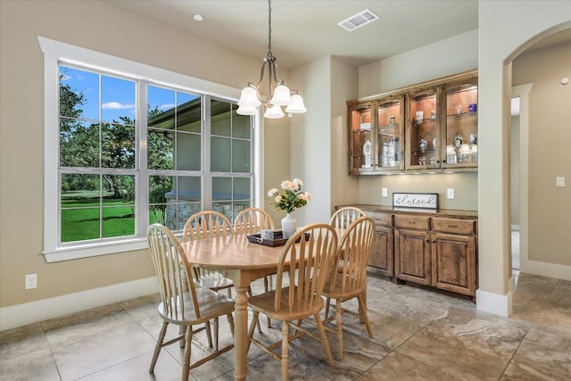 313 Aldea Cv, Georgetown, TX 78633 - dining area with arched walkways, plenty of natural light, and a chandelier