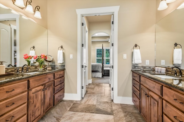 313 Aldea Cv, Georgetown, TX 78633 - bathroom with two vanities, connected bathroom, and backsplash