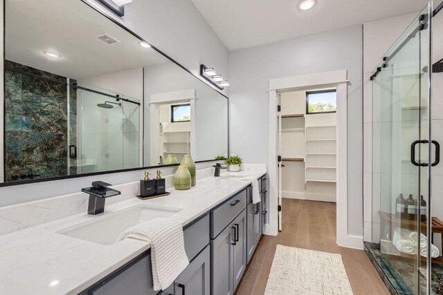 4803 Philco Dr, Austin, TX 78745 - bathroom with a spacious closet, healthy amount of natural light, double vanity, a stall shower, and recessed lighting