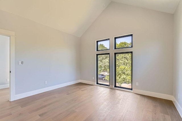 4803 Philco Dr, Austin, TX 78745 - spare room featuring high vaulted ceiling, light wood-style floors, and baseboards