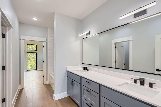 4803 Philco Dr, Austin, TX 78745 - full bathroom featuring double vanity, wood finished floors, baseboards, and recessed lighting