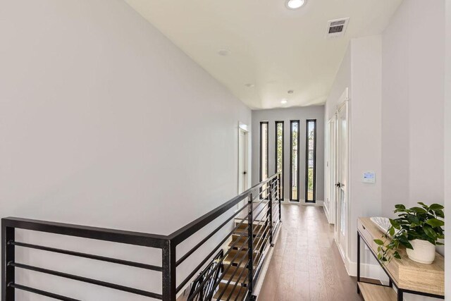 4803 Philco Dr, Austin, TX 78745 - hall with recessed lighting, an upstairs landing, hardwood / wood-style floors, and baseboards