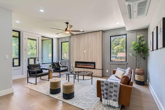 4803 Philco Dr, Austin, TX 78745 - living area with wood finished floors, recessed lighting, baseboards, a fireplace, and healthy amount of natural light