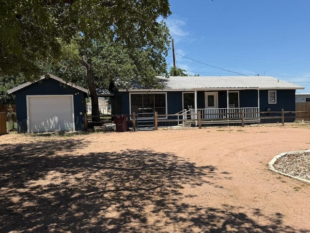 1503 Sioux Trl, Kingsland, TX 78639 - view of front of property featuring an outbuilding, a garage, and metal roof