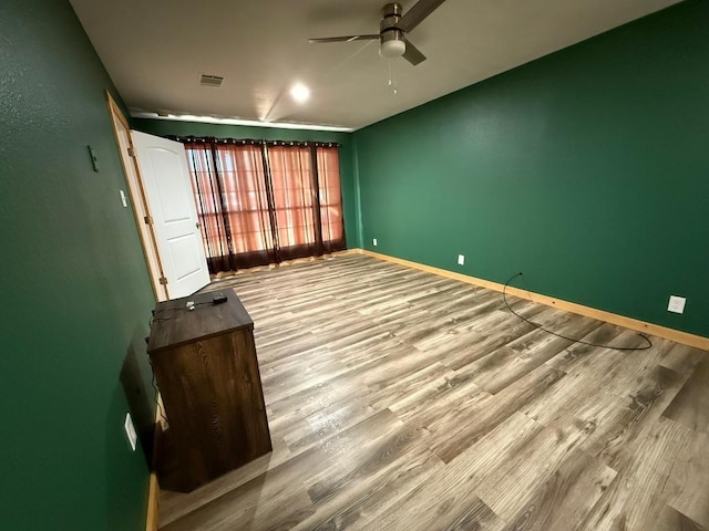 1503 Sioux Trl, Kingsland, TX 78639 - spare room with a ceiling fan, wood finished floors, and baseboards