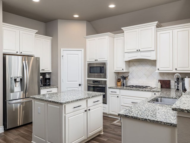 500 Cortona Ln, Georgetown, TX 78628 - kitchen featuring stainless steel appliances, a sink, white cabinets, dark wood-type flooring, and recessed lighting