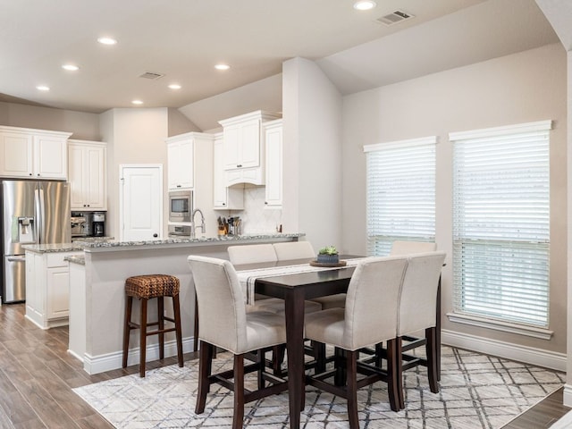500 Cortona Ln, Georgetown, TX 78628 - dining room with recessed lighting, light wood finished floors, baseboards, and arched walkways