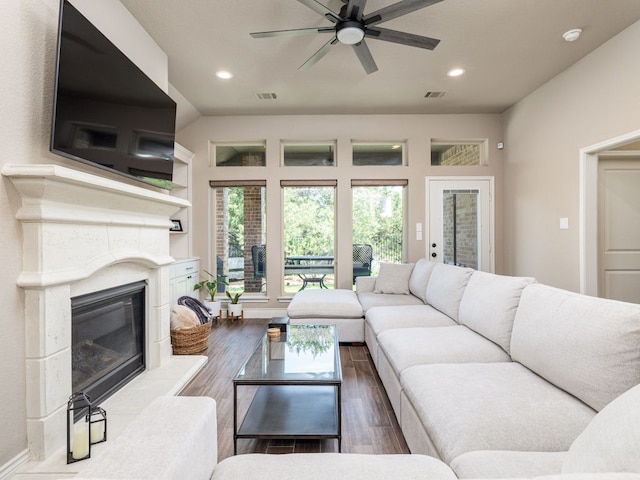 500 Cortona Ln, Georgetown, TX 78628 - living room with a high end fireplace, dark wood finished floors, ceiling fan, and recessed lighting