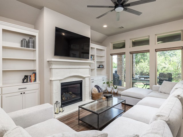 500 Cortona Ln, Georgetown, TX 78628 - living area featuring a ceiling fan, a fireplace, built in features, wood finished floors, and vaulted ceiling