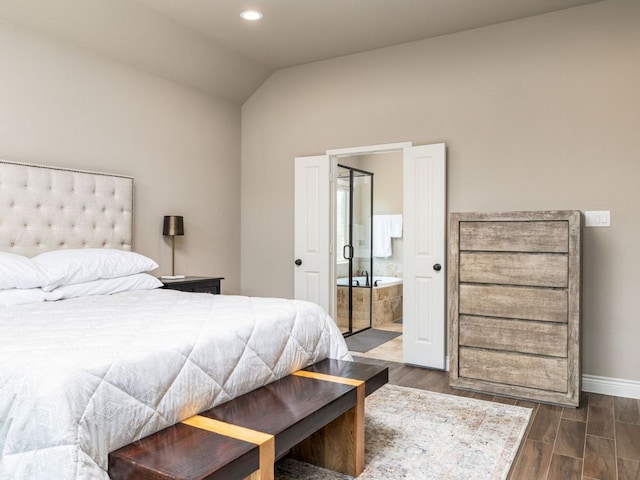 500 Cortona Ln, Georgetown, TX 78628 - bedroom with dark wood-type flooring, baseboards, vaulted ceiling, recessed lighting, and ensuite bath