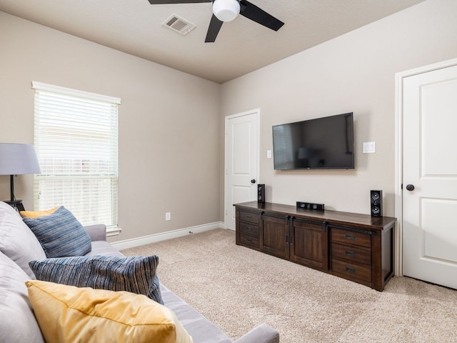500 Cortona Ln, Georgetown, TX 78628 - living area featuring light carpet, ceiling fan, and baseboards
