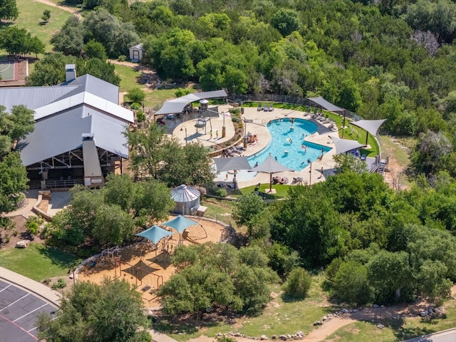 500 Cortona Ln, Georgetown, TX 78628 - drone / aerial view of a pool and a heavily wooded area