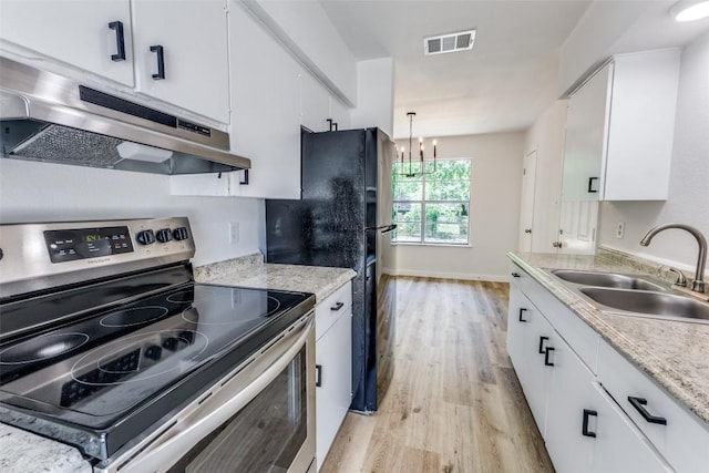 4709 Brassiewood Dr, Austin, TX 78744 - kitchen featuring electric stove, under cabinet range hood, a sink, light wood-type flooring, and white cabinets