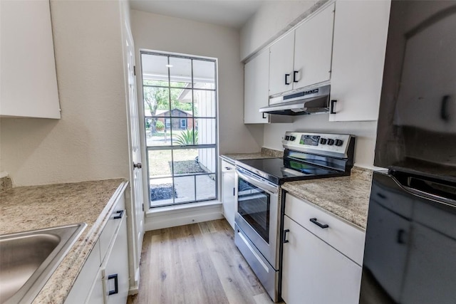 4709 Brassiewood Dr, Austin, TX 78744 - kitchen featuring stainless steel electric range, under cabinet range hood, white cabinets, light wood finished floors, and light countertops