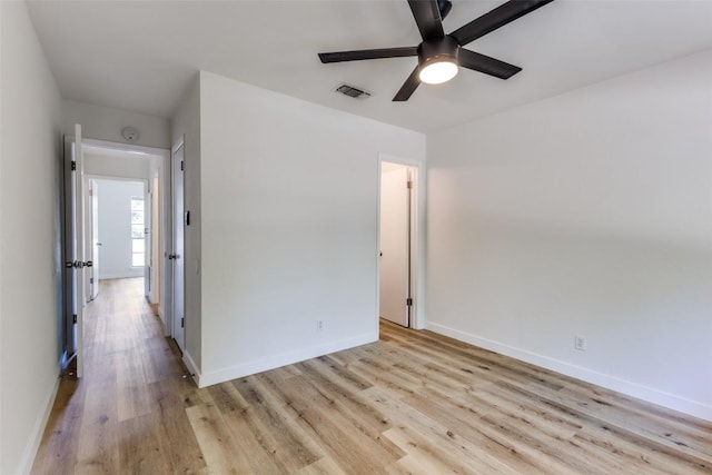 4709 Brassiewood Dr, Austin, TX 78744 - unfurnished bedroom with light wood finished floors, baseboards, and a ceiling fan