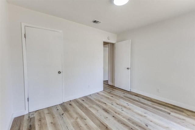 4709 Brassiewood Dr, Austin, TX 78744 - unfurnished bedroom with light wood-type flooring and baseboards