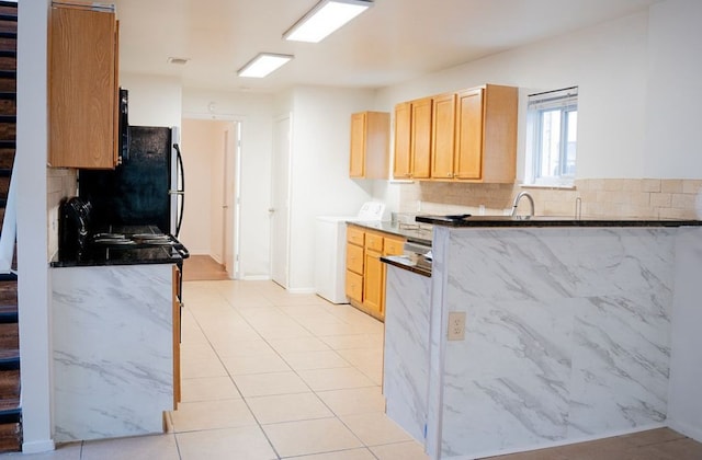 2841 San Gabriel St, Austin, TX 78705 - kitchen with washer / dryer, freestanding refrigerator, backsplash, and light brown cabinets