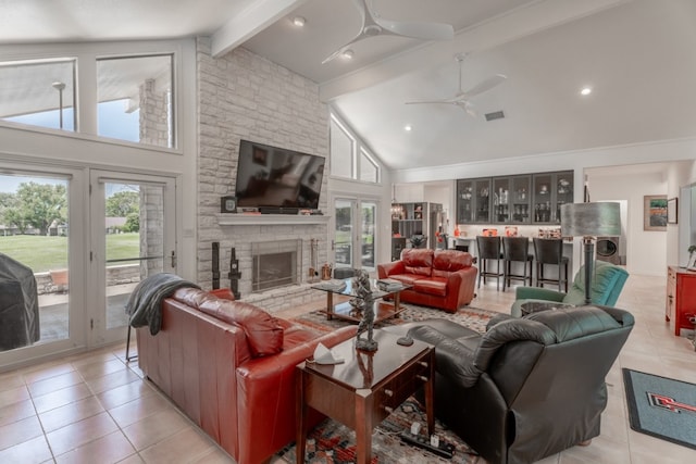 2704 Aurora, Horseshoe Bay, TX 78657 - living room with high vaulted ceiling, light tile patterned floors, a ceiling fan, beamed ceiling, and a stone fireplace