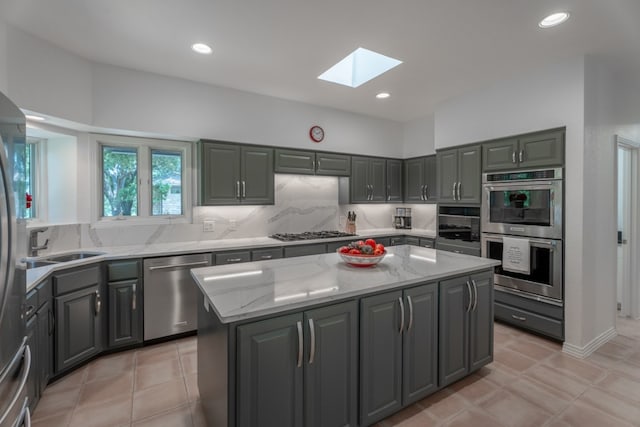 2704 Aurora, Horseshoe Bay, TX 78657 - kitchen featuring appliances with stainless steel finishes, gray cabinetry, a skylight, and recessed lighting