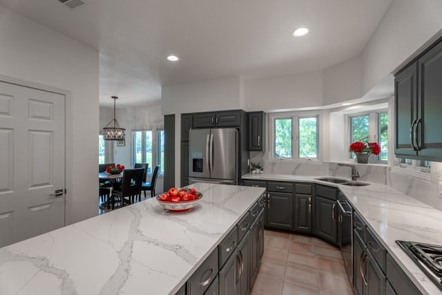 2704 Aurora, Horseshoe Bay, TX 78657 - kitchen with stainless steel appliances, a chandelier, light stone countertops, recessed lighting, and light tile patterned floors